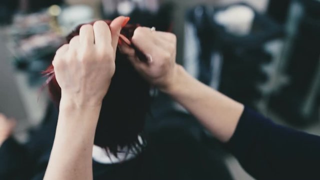 Hairdresser puts a mask on his hair and puts it by his hands close up