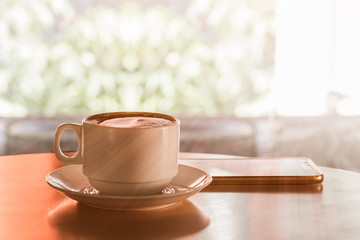 Cup of hot coffee on wood table