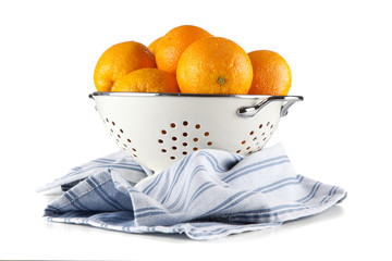 Fresh oranges in a colander