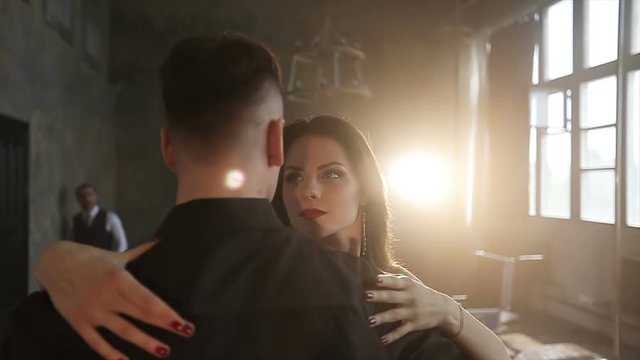 Businessman is looking at a dancing couple.
