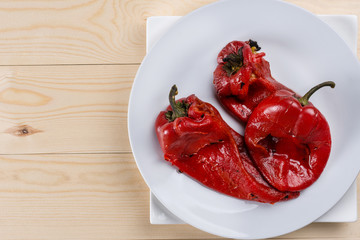 Fried red paprika on the grill on the wooden table