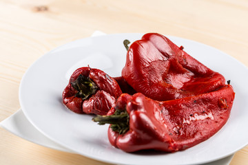 Closeup macro grilled fresh red paprika served on the white plate