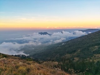 sea of cloud on the top of mountain. Beautiful nature in sunset time. 