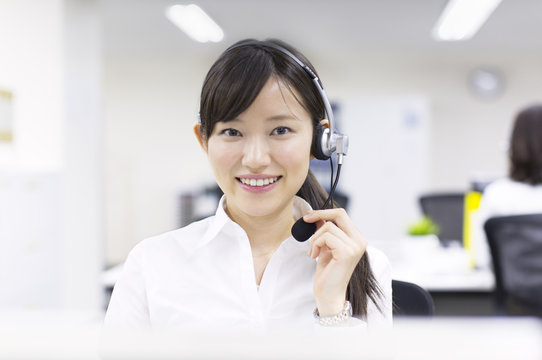 Young Businesswoman with Headset at Call Center 