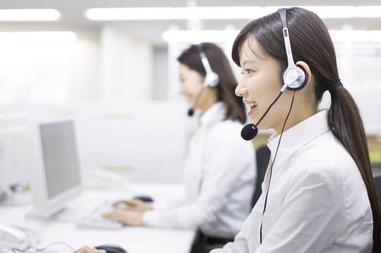 Young Businesswoman with Headset at Call Center 