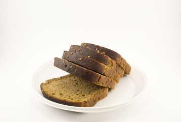 Black bread laid out on a plate