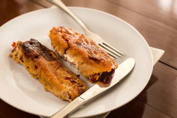 Grilled and fried in eggs paprika with knife and fork on the pla