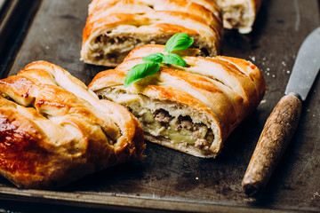 Homemade Fresh pie with meat and vegetables on the metal table background, dark rustic style. Top view, copy space