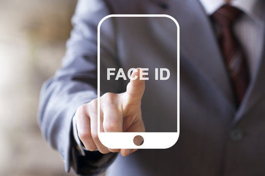 Businessman pressing button Face ID on smartphone