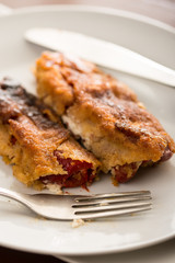 Grilled and fried in eggs paprika with knife and fork on the plate