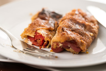 Grilled and fried in eggs paprika with knife and fork on the plate