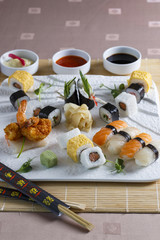 Sushi served on plate with sauces