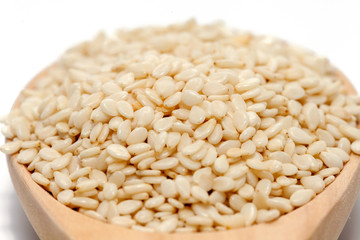 white Sesame on wood spoon on white background