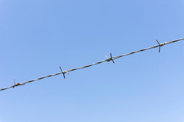 Barbed wire and sky