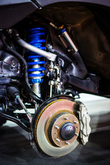 Fototapeta na wymiar Front disc brake system on race car and detail of a wheel hub