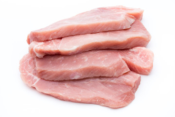 Fresh pork fillet with basil on a white background.