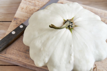 White pattypan squash (patty pan) on cutting board