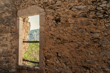 Castle wall with window looking out into nature