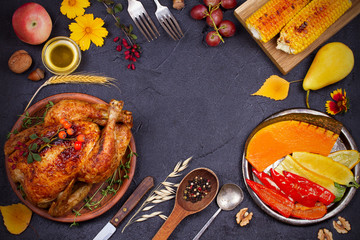 Chicken or turkey, fruits and grilled autumn vegetables: corn, pumpkin, paprika. Thanksgiving Day food concept. Harvest or Thanksgiving background. View from above, top shot horizontal, frame