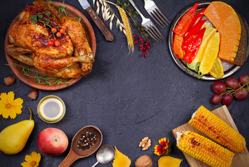 Chicken or turkey, fruits and grilled autumn vegetables: corn, pumpkin, paprika. Thanksgiving Day food concept. Harvest or Thanksgiving background. View from above, top shot horizontal, frame