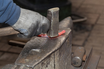 Making the horseshoe from heated red rod