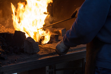 Making the horseshoe from heated red rod