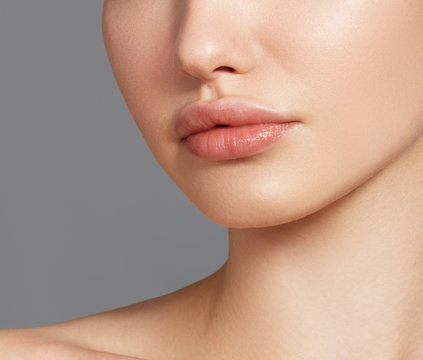 Sexy plump full lips. Close-up face detail. Perfect natural lip makeup. Close up photo with beautiful female face
