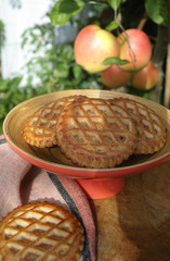 Traditional Dutch autumn apple filled cookies server in the garden under apple tree with big ripe apples