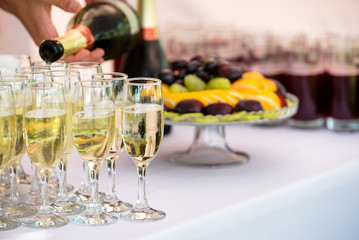 Waiter is pouring champagne outdoor