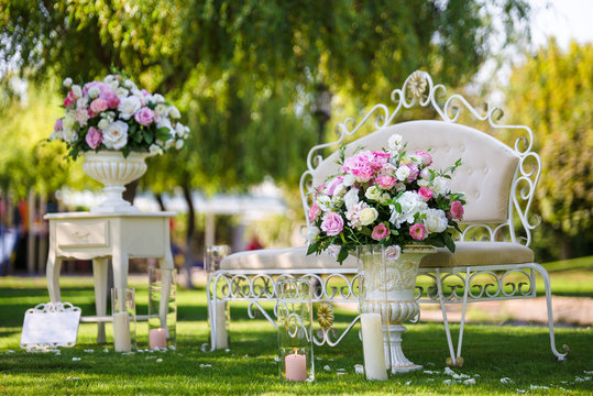 Luxury furniture photo zone in the garden decorated flowers in vases