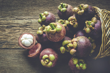 Mangosteen fruit on wood table with top view and process retro style