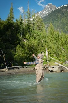 Side view of man fishing in river