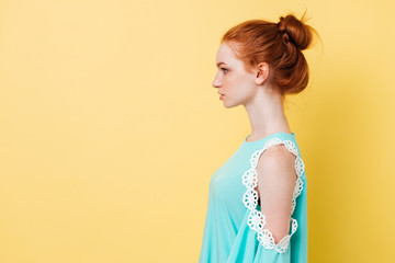 Photo in profile of pretty ginger woman in dress