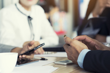 Business people using smartphone in conference room