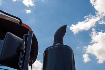 Naklejka premium Tractor exhaust pipe. blue sky background
