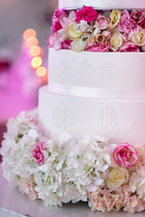 Traditional large many tiers wedding cake decorated flowers
