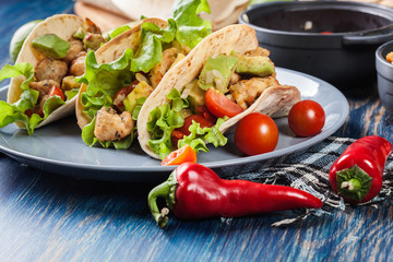 Authentic mexican tacos with chicken and salsa with avocado, tomatoes and chillies