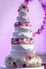 Obraz na płótnie Canvas Traditional large many tiers wedding cake decorated flowers
