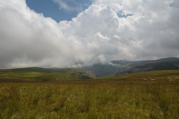 Fototapeta premium Russia, Republic of Kabardino-Balkaria, time lapse. Summer in the mountains of the Caucasus. Formation and movement of clouds over mountains peaks.