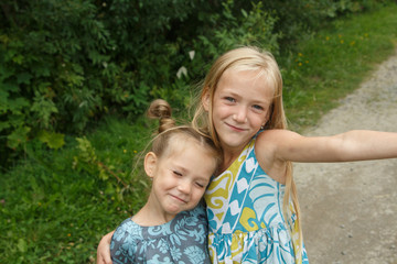 Fototapeta na wymiar Little girls taking selfie Two sisters fooling 