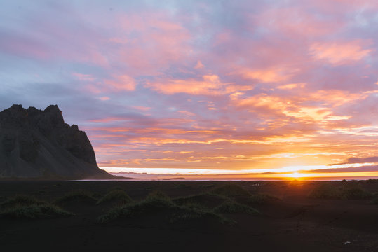 Sunrise at Stokksnes beach Iceland with mountain and orange and purple clouds