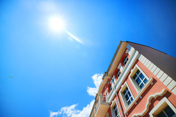 Old house against the sky and sun