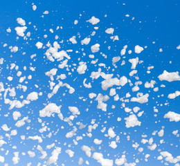 White foam against the blue sky as background