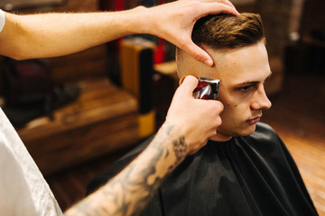 Haircut men Barbershop. Men's Hairdressers; barbers. Barber cuts the client machine for haircuts.