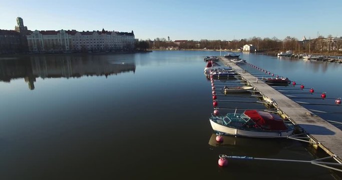 4K aerial view drone footage of Helsinki Baltic Sea lagoon area, city skyline with vintage architecture and boats in summer evening, the capital of Finland Suomi, northern Europe