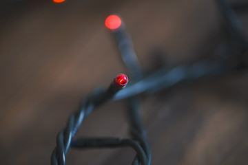 Christmas lights on wooden table.