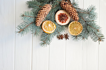 dried orange slices, fir cones on spruce branches on wooden background. top view. Christmas or New Year card