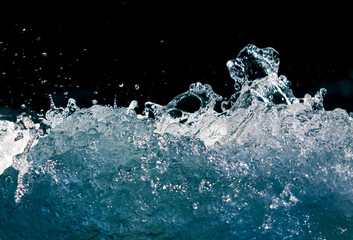 Splash of stormy water in the ocean on a black background