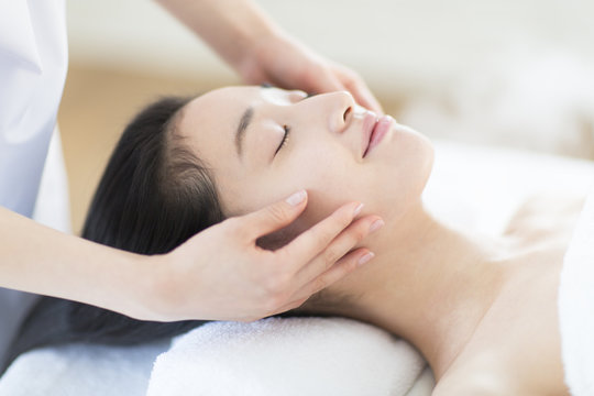 Woman Receiving Facial Massage At Spa