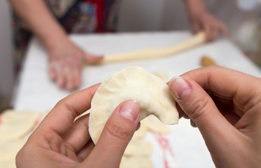 Cook cooks vareniki with potatoes